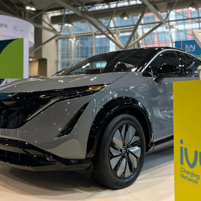 AutoShow event from 2023 with electric vehicle car and charger display.