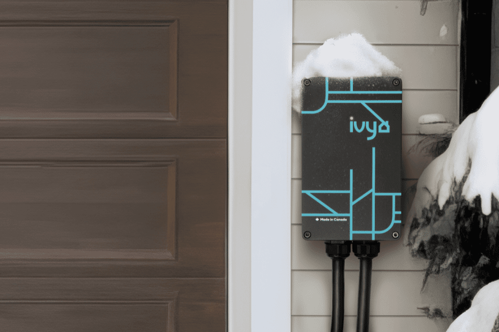 Ivy Home smart level 2 electric vehicle charger set up in front of house with snowy background.
