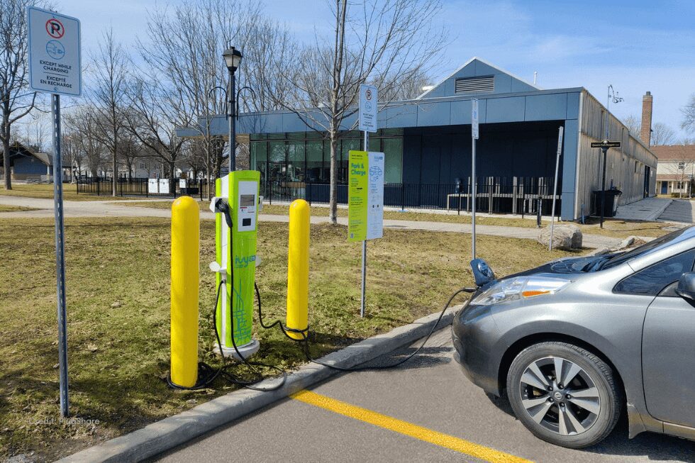 Gray electric vehicle charging at level 2 charger.